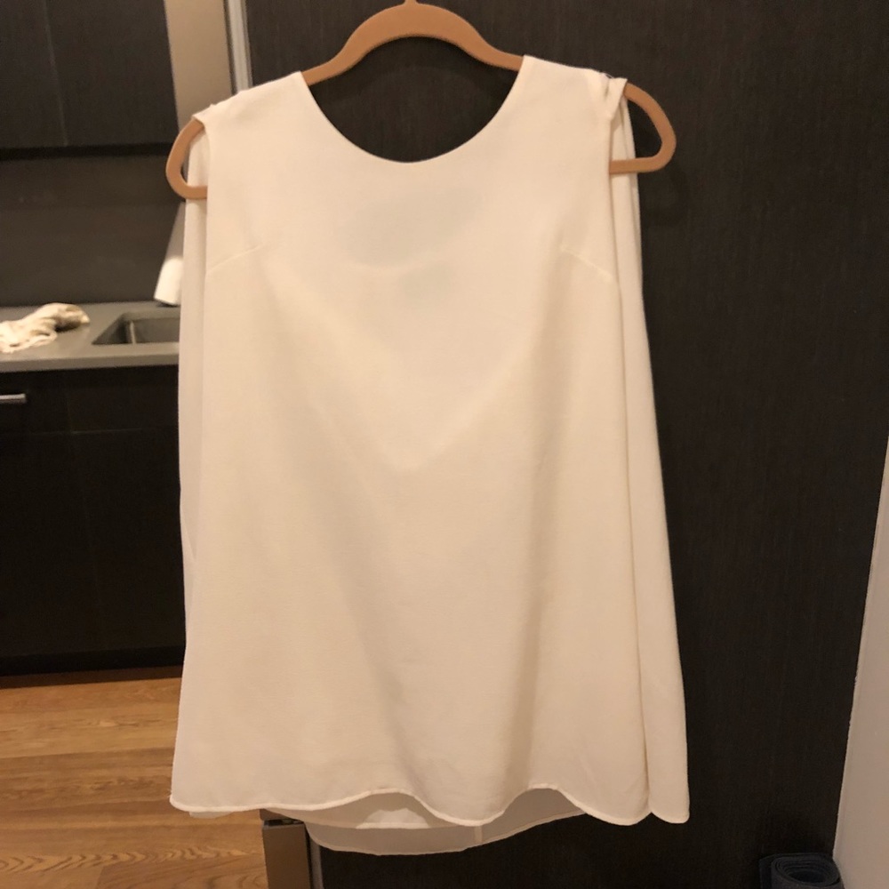 Sleek white mini dress with attached cape detail